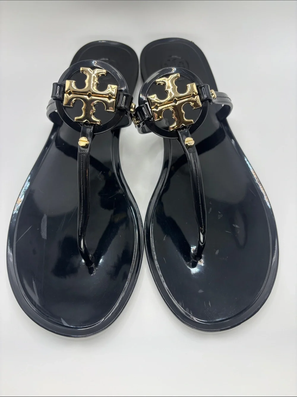 Tory Burch Black Jelly Thong Sandals with Gold Logo Medallions
